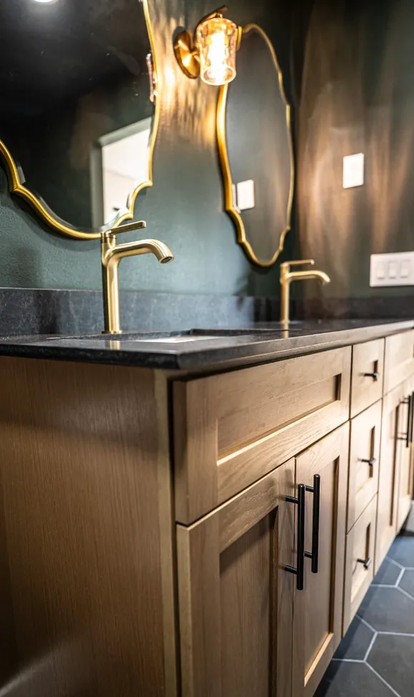 Same vanity side angle with gold mirrors and brass faucets